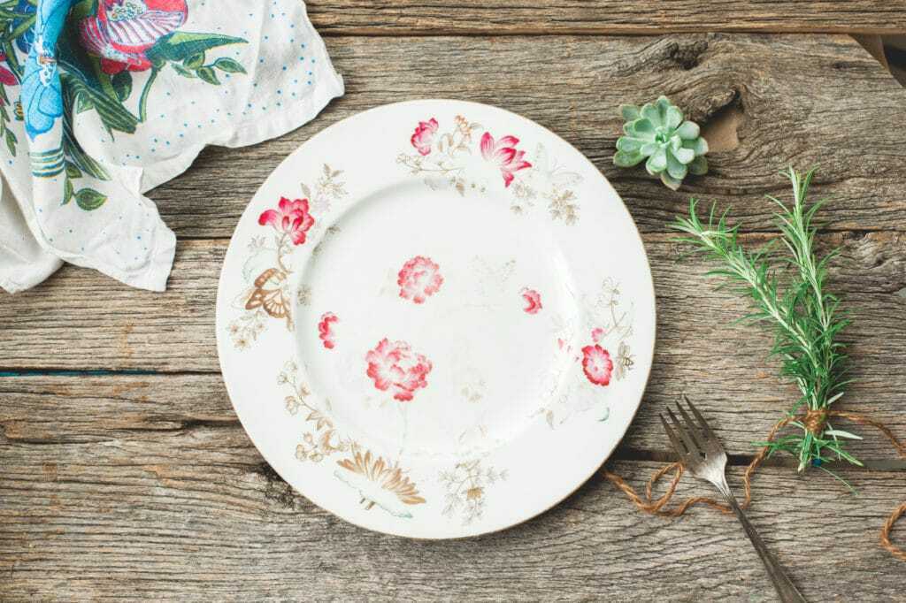 vintage floral plate with succulent and rosemary table scene stock photography image