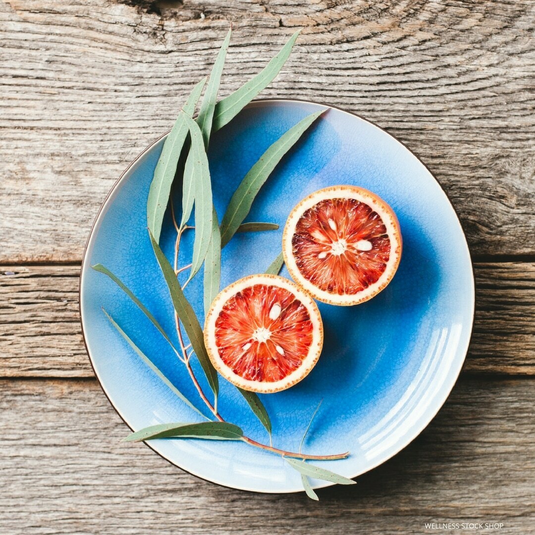 social media stock photo image of fresh blood orange citrus on blue plate