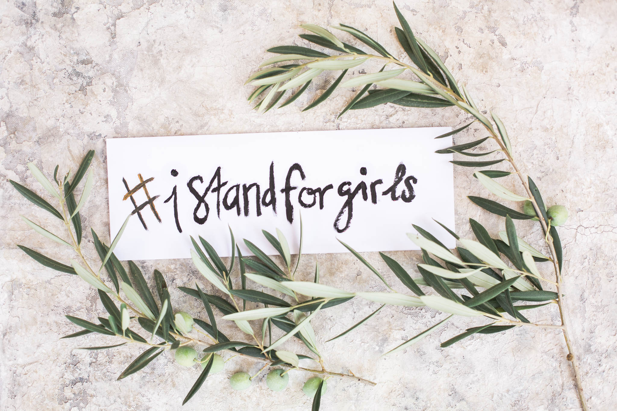I stand for girls sign with olive leaves