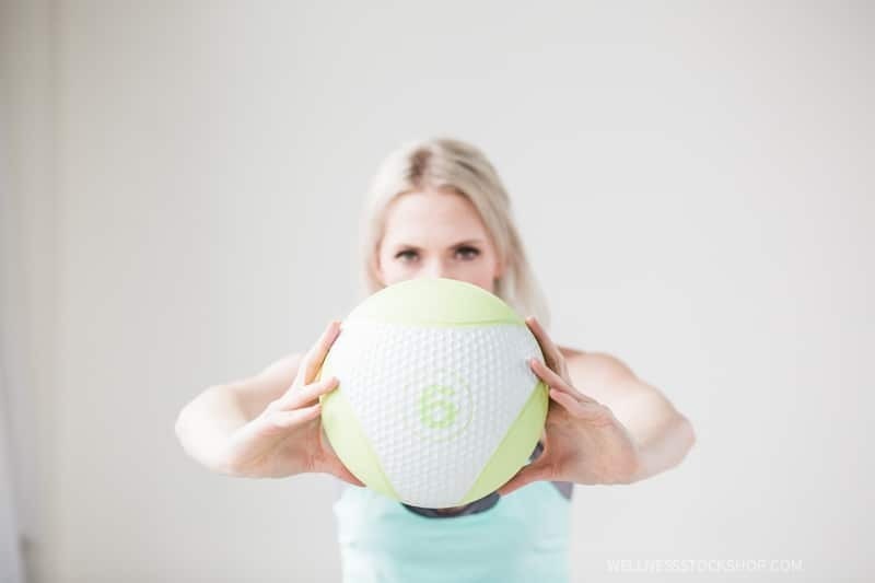 beautiful mature fit caucasian blond woman holding medicine ball minimalism exercise stock photo image
